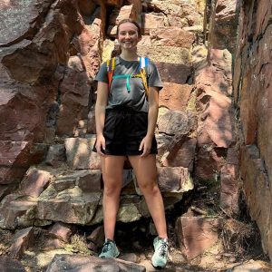 person standing in front of rocks