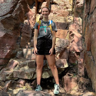 person standing in front of rocks