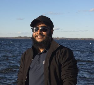 man smiling with water in background