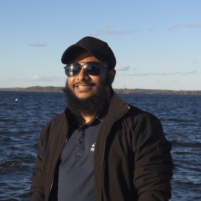 man smiling with water in background
